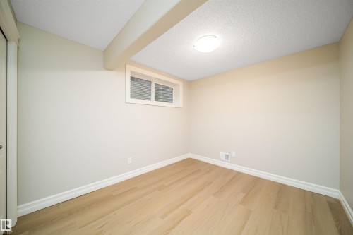 Room featuring light-toned wood-finish flooring - 11312 13 Ave Sw, Edmonton, AB 
