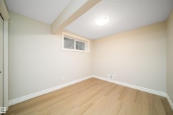 Room featuring light-toned wood-finish flooring - 