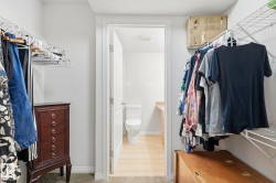 Walk-in closet featuring wire shelving, hanging rods, and carpeted flooring - 