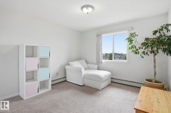 Windowed interior space with light gray carpet flooring and white walls - 
