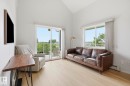Vaulted ceilings complement light wood-finish flooring - 426 3425 19 Street, Edmonton, AB 