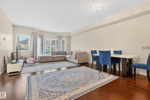 Open-concept living area with dark wood-finish flooring - 226 4304 139 Avenue, Edmonton, AB 