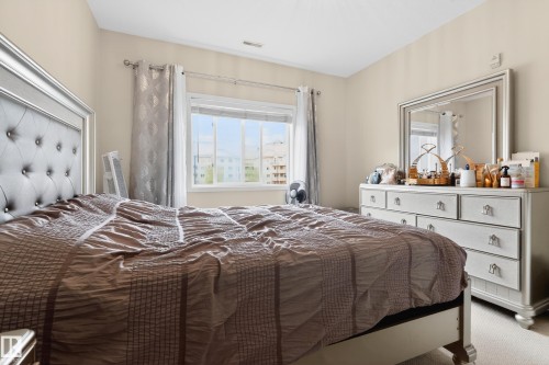Light-filled room featuring a broad window, neutral wall tones, and carpeted flooring - 226 4304 139 Avenue, Edmonton, AB 