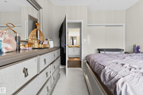 Bedroom with light-toned walls and wood-finish flooring - 226 4304 139 Avenue, Edmonton, AB 