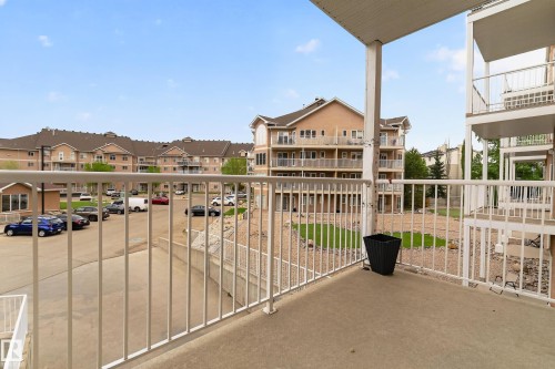 Private concrete balcony with white metal railings - 226 4304 139 Avenue, Edmonton, AB 