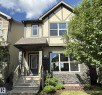 Two-story stucco and siding exterior featuring dark trim accents - 3110 Paisley Road, Edmonton, AB 