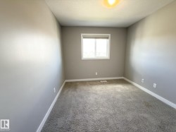Neutral gray wall paint, white trim, and light gray carpeting - 