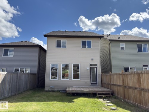 Rear exterior with light beige siding and a brown shingle roof - 3110 Paisley Road, Edmonton, AB 