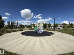 Community playground featuring a colorful play structure on a dark safety surface - 