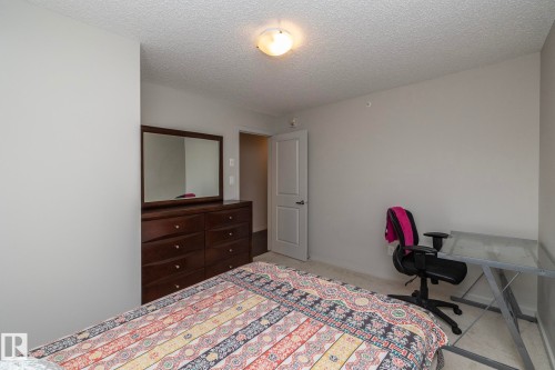 Bedroom featuring light gray walls, textured ceiling, a flush-mount ceiling light, and light-toned carpet flooring - 431 344 Windermere Road, Edmonton, AB - Indoor Photo Showing Bedroom