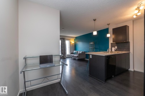 Open-concept living space with dark wood-finish flooring - 431 344 Windermere Road, Edmonton, AB - Indoor Photo Showing Other Room