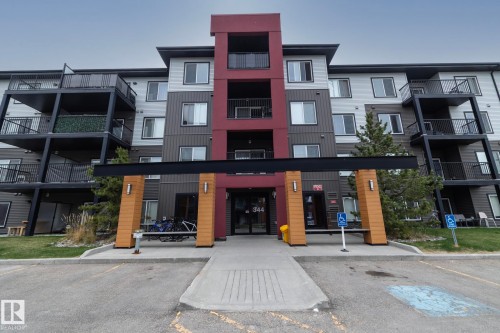 Contemporary multi-story building featuring a red, gray, and light-toned facade - 431 344 Windermere Road, Edmonton, AB - Outdoor With Balcony With Facade