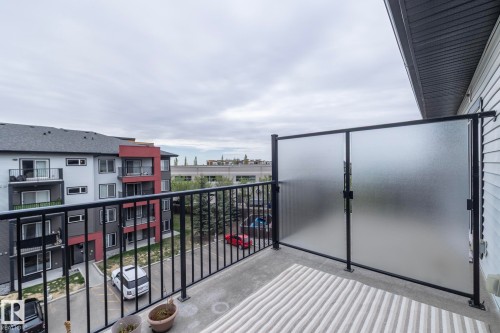 Private balcony featuring textured privacy screens, black metal railings, and concrete flooring - 431 344 Windermere Road, Edmonton, AB - Outdoor With Balcony