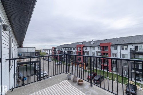 Private concrete balcony featuring black metal railings and a modern building exterior - 431 344 Windermere Road, Edmonton, AB - Outdoor With Balcony With Exterior