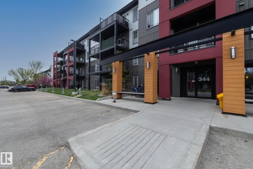 Modern multi-story building featuring a maroon and gray facade with black balcony railings - 431 344 Windermere Road, Edmonton, AB - Outdoor With Balcony