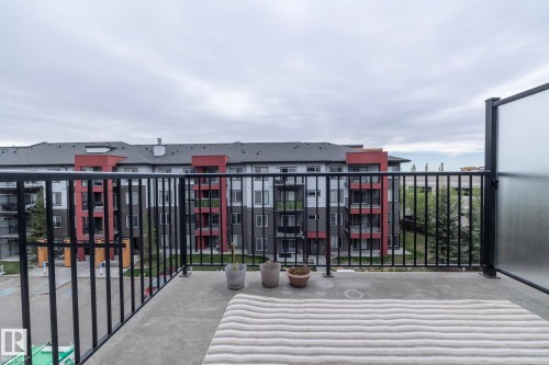 Spacious concrete balcony with black metal railings and a frosted privacy panel - 431 344 Windermere Road, Edmonton, AB - Outdoor With Balcony