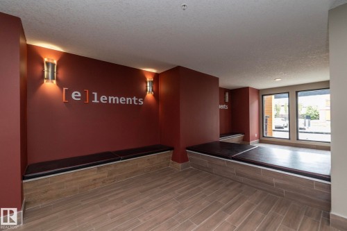 Indoor lounge area featuring wood-finish tile flooring, recessed ceiling lighting, and built-in seating with dark cushions - 431 344 Windermere Road, Edmonton, AB - Indoor Photo Showing Other Room