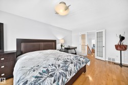 Bright room featuring wood-finish flooring and white walls - 