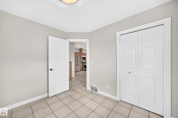 Room with light gray walls and square tile flooring - 