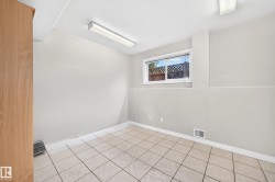 Room featuring neutral wall finishes and light-toned tile flooring - 