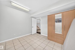 Tiled flooring and light gray walls create a neutral palette - 