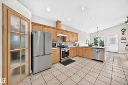 Kitchen featuring light wood cabinetry and stainless steel appliances - 