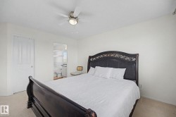 Bedroom featuring light-toned walls and carpeted flooring - 