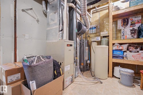 Utility area featuring a furnace, water heater, water softener, and a water filtration system - 262 Dunvegan Road, Edmonton, AB 