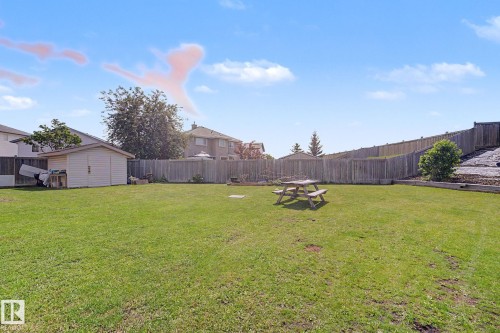 Expansive grassy yard with a storage shed and full perimeter fencing - 262 Dunvegan Road, Edmonton, AB 