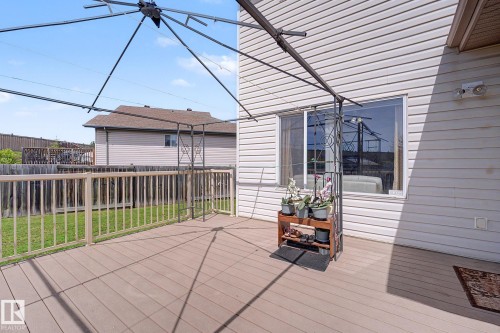 Expansive outdoor deck with composite decking and light-toned wood railings, featuring a structural metal frame - 262 Dunvegan Road, Edmonton, AB 