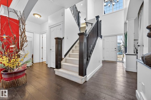 Entrance foyer with dark wood-style flooring and suspended lighting - 1660 Malone Way, Edmonton, AB 