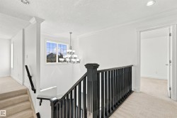 White walls with crown molding, recessed lighting, and a chandelier - 
