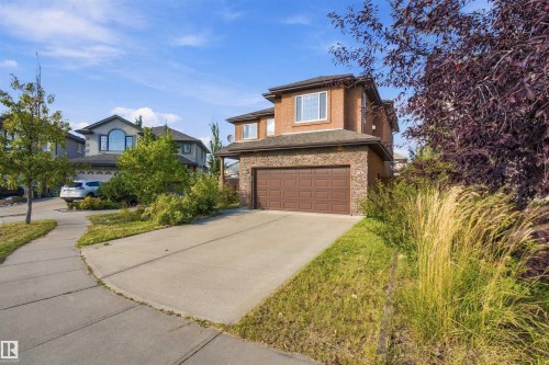 Stucco and stone exterior with an attached garage - 1660 Malone Way Nw, Edmonton, AB 