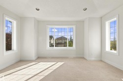 Recessed ceiling lighting, white walls, and multiple grid-pattern windows - 