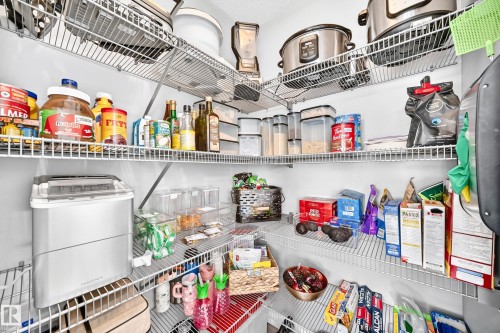 White wire shelving system providing ample storage within a dedicated pantry space - 93 Richmond Link, Fort Saskatchewan, AB 