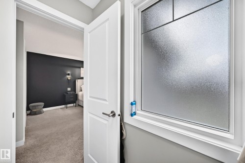 Frosted privacy window with white trim, offering natural light - 93 Richmond Link, Fort Saskatchewan, AB 