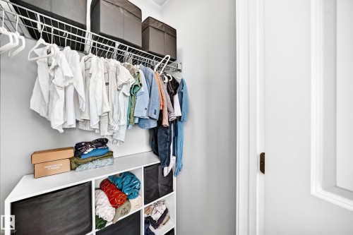 Integrated closet system featuring wire shelving, multiple hanging rods, and built-in cubbies - 93 Richmond Link, Fort Saskatchewan, AB 