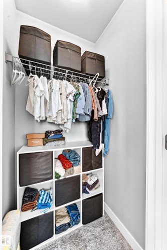 Integrated wire shelving system provides overhead storage and hanging space - 93 Richmond Link, Fort Saskatchewan, AB 