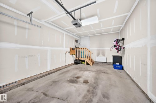 Concrete garage floor with drywall finished walls and ceiling - 93 Richmond Link, Fort Saskatchewan, AB 