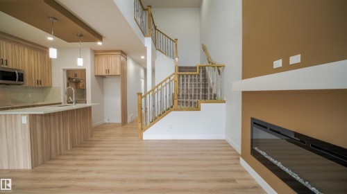 Open-concept living space with light wood-finish flooring - 3708 40 Ave, Beaumont, AB 