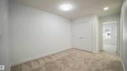 Neutral-toned carpeting and light gray walls create a versatile interior space - 