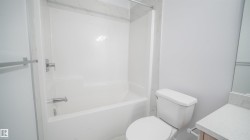 White acrylic tub and shower combination with chrome fixtures - 
