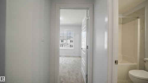 Hallway featuring white walls and trim - 3708 40 Ave, Beaumont, AB 