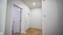 Entryway featuring wood-finish flooring, recessed lighting, and a white paneled door with frosted glass insert - 3708 40 Ave, Beaumont, AB 