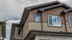 Exterior featuring horizontal siding, shake siding, and stone veneer accents - 