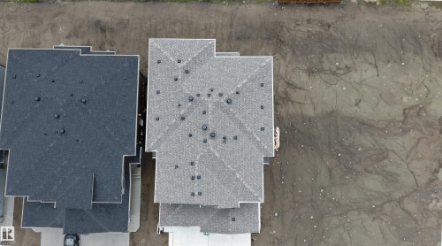 New construction residence featuring a multi-gabled roofline with asphalt shingles - 3708 40 Ave, Beaumont, AB 