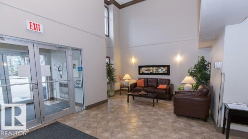 Spacious lobby featuring high ceilings, light neutral wall paint, and tiled flooring - #141 11505 Ellerslie Rd, Edmonton, AB 