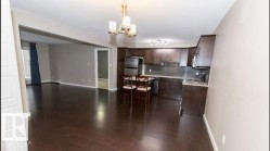 Kitchen and living area featuring dark wood-finish flooring - 