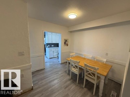 Dining area featuring wood-finish flooring and a ceiling-mounted light fixture - 4917 45 Avenue, Vegreville, AB - Indoor