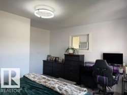 White walls and ceiling with a ceiling-mounted light fixture, window with a white frame, and light-colored flooring - 